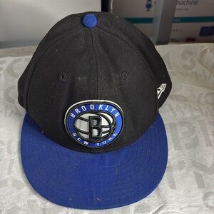 “Brooklyn ‘B’ New York” with Brooklyn Nets Logo. Black and Blue Fitted hat.